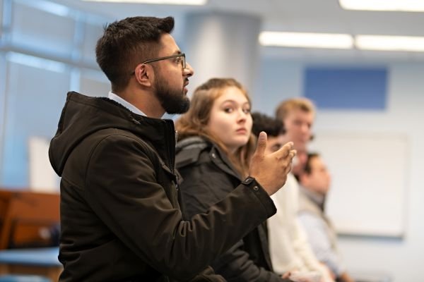 Visiting aspiring medical students ask the faculty panel questions about medical school.