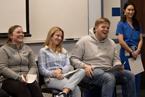 Student mentors share a moment of laughter in the panel line.