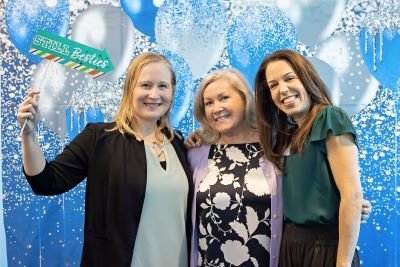 SLP faculty and staff hold up sign
