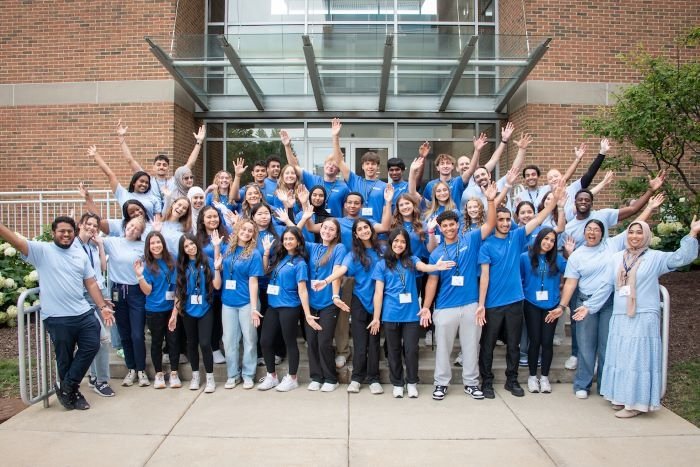 HCI students and mentors wave to camera