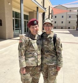 Mom and daughter pose in military gear