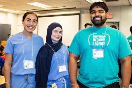 Nadene Abdalla (CDMA '29) stands with her mentee and another mentor at the MIMS event
