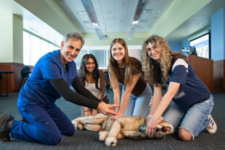 Dr. da Cunha teaches high school students to perform canine CPR
