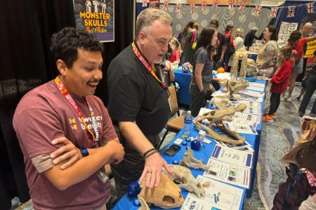 A Midwestern student and faculty member show anatomical skulls at Fan Fusion